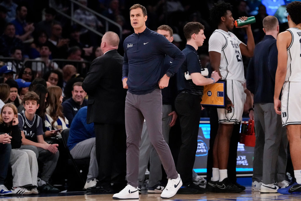 Duke's head coach Jon Scheyer, center, looks on during the first half of an NCAA college basketball game against Texas Tech, Saturday, Dec. 20, 2025, in New York. (AP Photo/Yuki Iwamura)