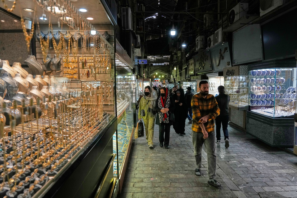 People walk at a gold market in Tehran's Grand Bazaar, Iran, Saturday, Nov. 29, 2025. (AP Photo/Vahid Salemi)