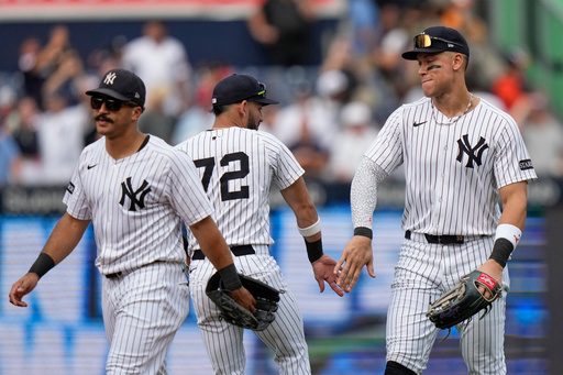 New York Yankees' Aaron Judge, right, celebrates with teammates José Caballero, center, and Trent Grisham, left, of a baseball game Saturday, Sept. 27, 2025, in New York. (AP Photo/Frank Franklin II) New York Yankees' Aaron Judge, right, celebrates with teammates José Caballero, center, and Trent Grisham, left, of a baseball game Saturday, Sept. 27, 2025, in New York. (AP Photo/Frank Franklin II)