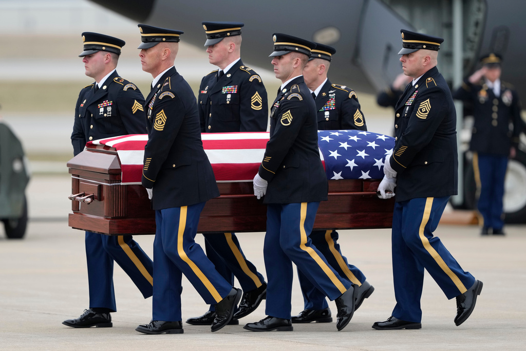 The remains of Staff Sgt. Edgar Brian Torres-Tovar, 25, of Des Moines, Iowa, one of two Iowa National Guard members killed in an attack in the Syrian desert, is moved during a dignified transfer at the Des Moines International Airport in Des Moines, Iowa, Wednesday, Dec. 24, 2025. (AP Photo/Charlie Neibergall)
