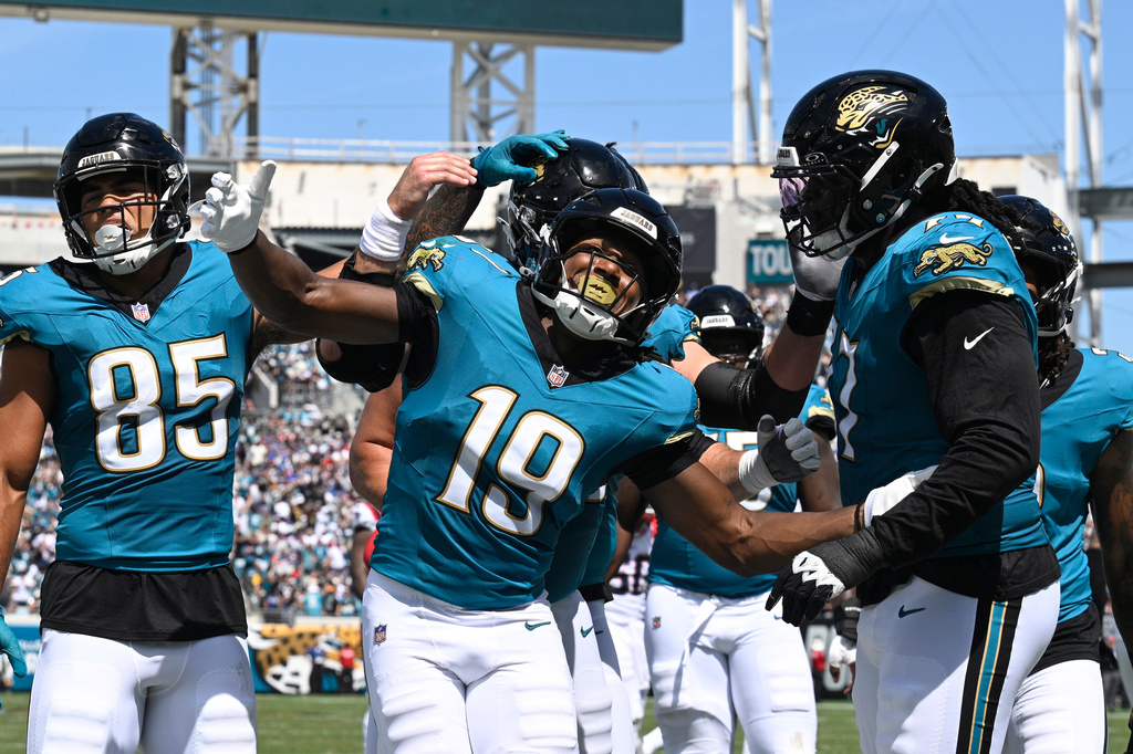 Jacksonville Jaguars wide receiver Josh Cameron (19) celebrates with teammates after scoring a touchdown against the New England Patriots in the first half during an NFL football game in Jacksonville, Fla., Sunday, Sept. 27, 2026. (AP Photo/Phelan M. Ebenhack)