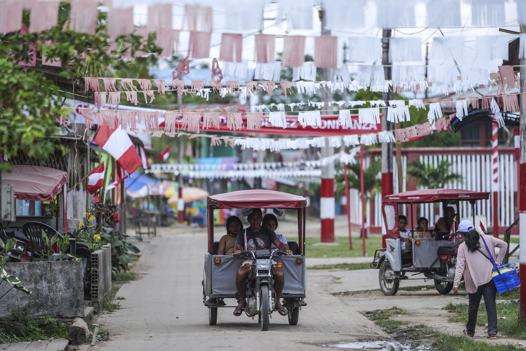 People use a taxi in Santa Rosa, Peru, an island on the Amazon River on the border with Colombia, Monday, Aug. 18, 2025. (AP Photo/Ivan Valencia)