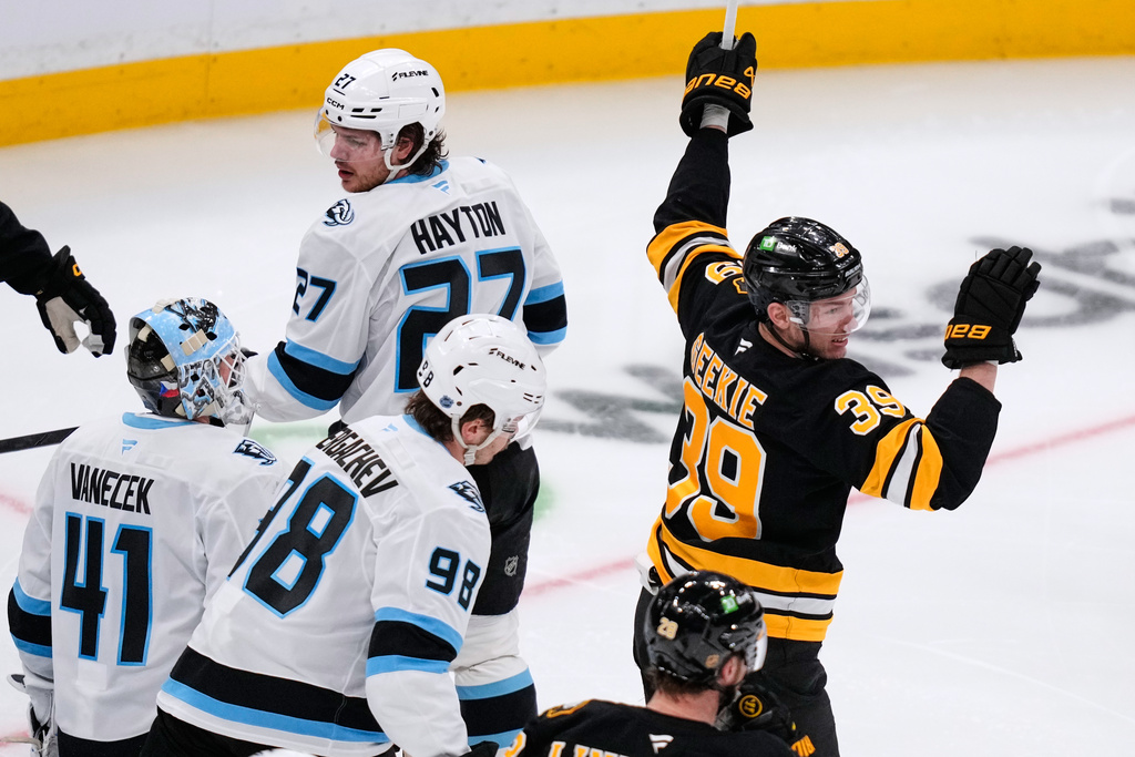 Boston Bruins center Morgan Geekie (39) celebrates after his goal against Utah Mammoth goaltender Vitek Vanecek (41), his second goal of the night, during the second period of an NHL hockey game, Tuesday, Dec. 16, 2025, in Boston. (AP Photo/Charles Krupa)