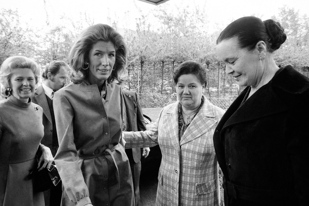 FILE - Nancy Kissinger, wife of U.S. Secretary of State Henry Kissinger, is shown into the house by Lydia Gromyko, wife of Soviet Foreign Minister Andrei Gromyko, right, at a meeting of the two ladies in the Soviet mission in Geneva, April 28, 1974. (AP Photo/Dieter Endlicher,File)