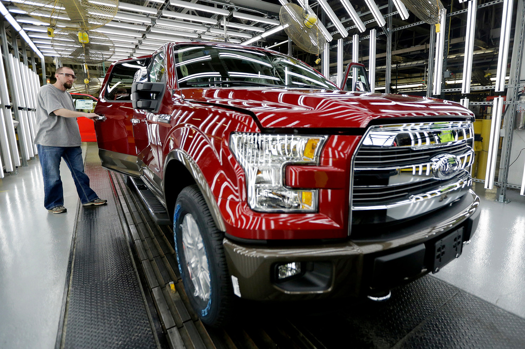 FILE - A worker inspects a new aluminum-alloy body Ford F-150 truck at the company's Kansas City Assembly Plant, March 13, 2015 in Claycomo, Mo. (AP Photo/Charlie Riedel, File)