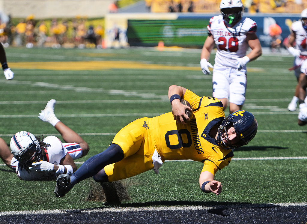 West Virginia's Nicco Marchiol scores a touchdown during the first half an NCAA college football game against Robert Morris, Saturday, Aug. 30, 2025, in Morgantown, W.Va.. (Ron Rittenhouse/The Dominion-Post via AP)
