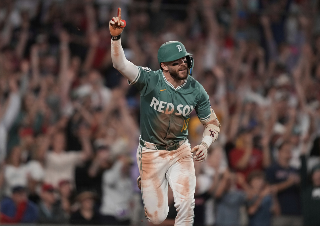 Boston Red Sox's Trevor Story celebrates his game-winning RBI single in the bottom of the ninth inning of a baseball game against the Miami Marlins at Fenway Park, Friday, Aug. 15, 2025, in Boston. (AP Photo/Charles Krupa)