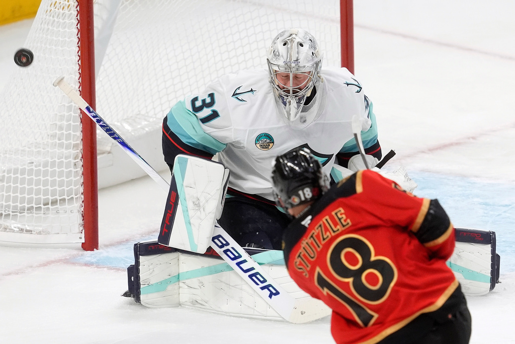 Ottawa Senators center Tim Stutzle (18) shoots the puck wide of the net past Seattle Kraken goaltender Philipp Grubauer (31) during first-period NHL hockey game action in Ottawa, Ontario, Thursday, Oct. 16, 2025. (Adrian Wyld/The Canadian Press via AP)