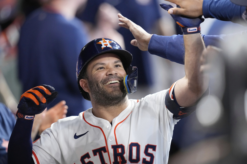 Houston Astros' Jose Altuve celebrates in the dugout after hitting a home run against the Colorado Rockies during the first inning of a baseball game Thursday, Aug. 28, 2025, in Houston. (AP Photo/David J. Phillip)