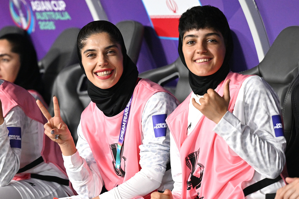 Iranian players gesture from the bench during the Women's Asia Cup soccer match between Iran and South Korea on the Gold Coast, Australia, Monday, March 2, 2026. (Dave Hunt/AAPImage via AP)