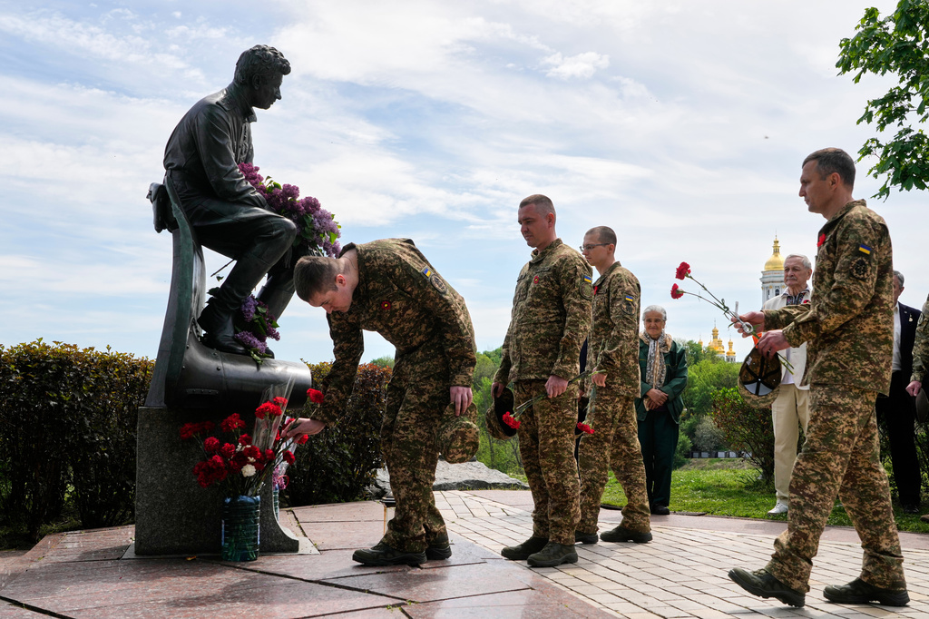 Ukrainian army officers lay flowers at a monument to pilots to mark Victory Day in World War II, in Kyiv, Ukraine, Friday, May 8, 2026, as the Russian attack on Ukraine continues. (AP Photo/Efrem Lukatsky)
