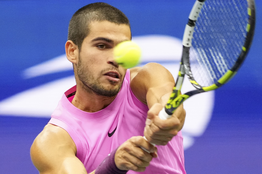 Carlos Alcaraz, of Spain, returns a shot to Jannik Sinner, of Italy, during the men's singles final of the U.S. Open tennis championships, Sunday, Sept. 7, 2025, in New York. (AP Photo/Kirsty Wigglesworth)