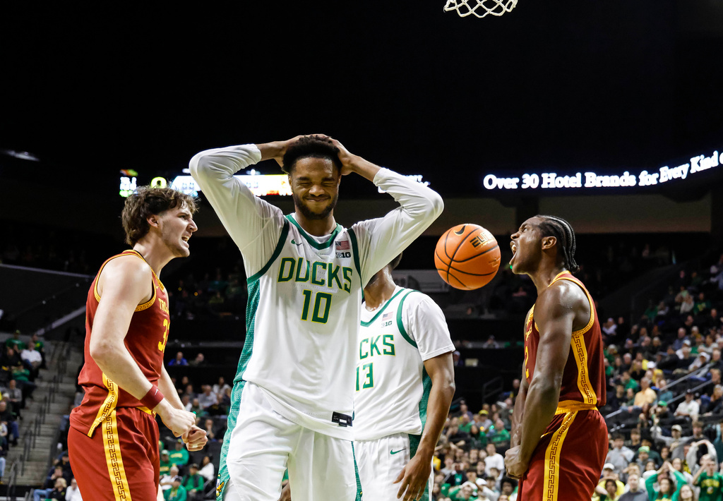 Southern California forward Ezra Ausar (2) celebrates a basket as Oregon forward Kwame Evans Jr. (10) reacts in the second half of an NCAA college basketball game in Eugene, Ore., Tuesday, Dec. 2, 2025. (AP Photo/Thomas Boyd)