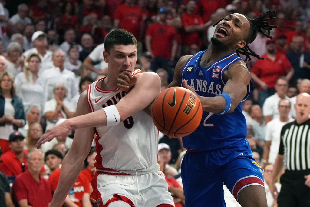 Kansas guard Corbin Allen (2) drives against Arizona forward Ivan Kharchenkov during the first half of an NCAA college basketball game, Saturday, Feb. 28, 2026, in Tucson, Ariz. (AP Photo/Rick Scuteri)