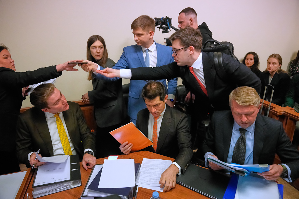 Participants gather in Moscow's Arbitration Court to hold a hearing to consider a lawsuit by Russia's Central Bank against Belgium-based financial clearinghouse Euroclear in Moscow, Russia, Friday, Jan. 16, 2026. (AP Photo/Pavel Bednyakov)