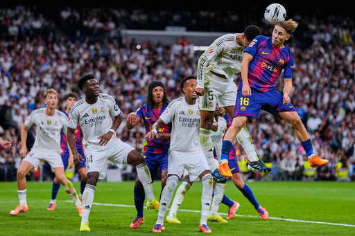 Barcelona's Fermin Lopez, top right, goes for a header with Real Madrid's Jude Bellingham during the Spanish La Liga soccer match between Real Madrid and Barcelona, in Madrid, Sunday, Oct. 26, 2025. (AP Photo/Manu Fernandez) Barcelona's Fermin Lopez, top right, goes for a header with Real Madrid's Jude Bellingham during the Spanish La Liga soccer match between Real Madrid and Barcelona, in Madrid, Sunday, Oct. 26, 2025. (AP Photo/Manu Fernandez)