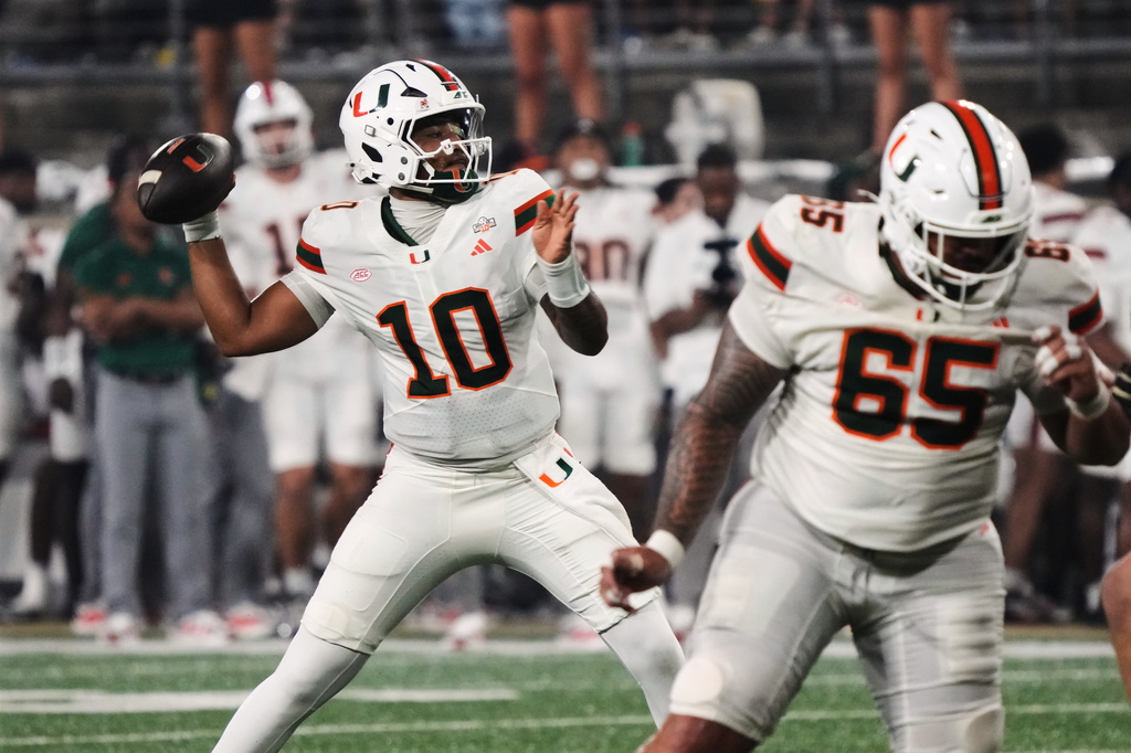 Miami quarterback Darian Mensah (10) looks to pass the ball against Wake Forest during the first half of an NCAA college football game in Winston-Salem, N.C., Friday, Sept. 18, 2026. (AP Photo/Chuck Burton)