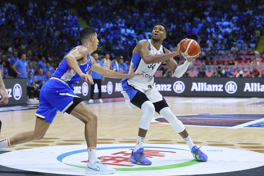 Italy's' Simone Fontecchio defends against Greece's Giannis Antetokounmpo during the Eurobasket, European Basketball Championship Group C match between Greece and Italy at the Spyros Kyprianou Arena in Limassol, Cyprus, Thursday, Aug. 28, 2025. (AP Photo/Chara Savvidou)