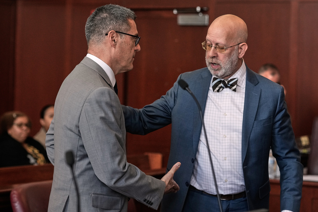Manhattan Assistant District Attorney Alfred Peterson, left, prepares to shake hands with Arnold Levine, defense attorney for Randy Santos, after Santos was sentenced in court for fatally beating four sleeping men on the streets in 2019, in New York, Thursday, May 28, 2026. (AP Photo/Richard Drew)