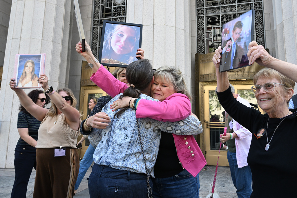 Lori Schott, center right, embraces Mary Rodee after the verdict in a landmark trial over whether social media platforms deliberately addict and harm children at Los Angeles Superior Court, Wednesday, March 25, 2026, in Los Angeles. (AP Photo/William Liang)