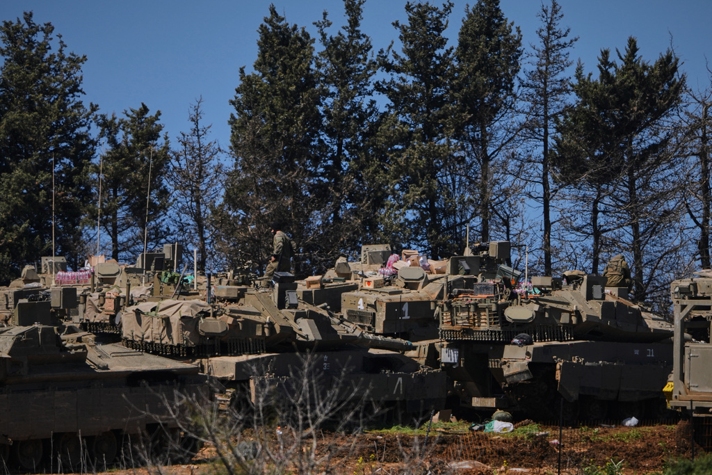 Israeli soldiers are seen along the border with Lebanon in northern Israel, Tuesday, March 17, 2026. (AP Photo/Ariel Schalit)