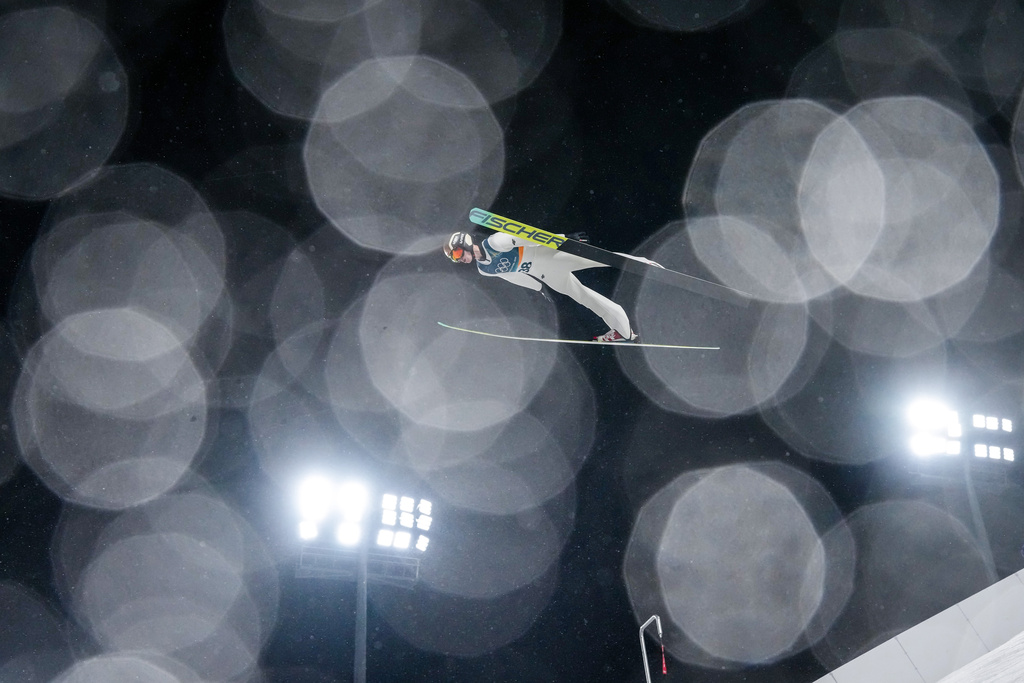 Kacper Tomasiak, of Poland, soars through the air during the ski jumping men's large hill individual at the 2026 Winter Olympics, in Predazzo, Italy, Saturday, Feb. 14, 2026. (AP Photo/Evgeniy Maloletka)