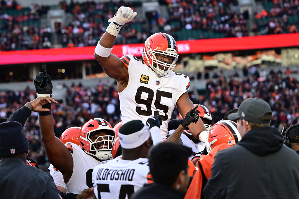 FILE - Cleveland Browns defensive end Myles Garrett, center, celebrates with teammates after breaking the NFL single season sack record during the second half of an NFL football game against the Cincinnati Bengals in Cincinnati, Jan. 4, 2026. (AP Photo/David Dermer, File)