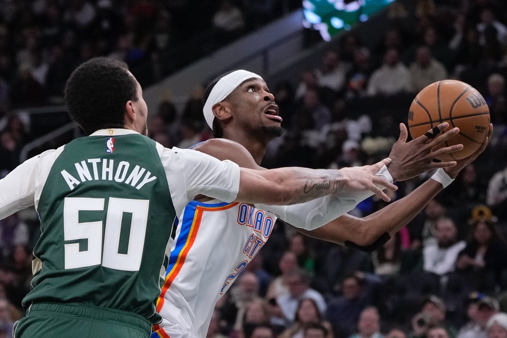 Oklahoma City Thunder's Shai Gilgeous-Alexander shoots past Milwaukee Bucks' Cole Anthony during the first half of an NBA basketball game Wednesday, Jan. 21, 2026, in Milwaukee. (AP Photo/Morry Gash)
