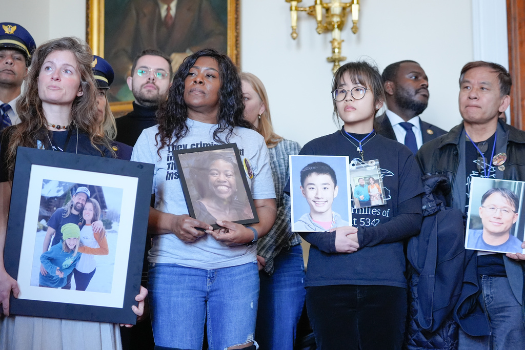 Family members of the people who were killed in the midair collision near Washington Reagan National Airport listen during a news conference as Rep. Don Beyer, D-Va., speaks, not shown, on Capitol Hill, Tuesday, Feb. 24, 2026, in Washington. (AP Photo/Mariam Zuhaib)