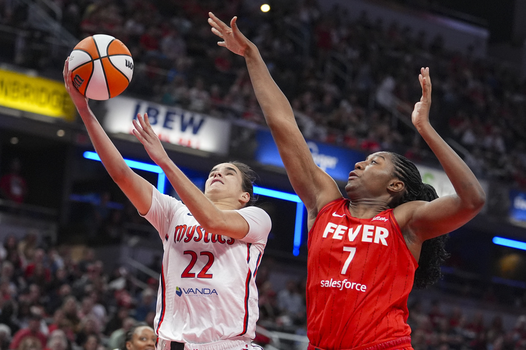 Washington Mystics guard Sonia Citron (22) shoots in front of Indiana Fever forward Aliyah Boston (7) in the second half of a WNBA basketball game in Indianapolis, Friday, Aug. 15, 2025. (AP Photo/Michael Conroy)