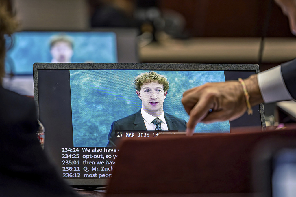 Lawyers for the plaintiff watch on a laptop as a recording of Meta Founder and CEO Mark Zuckerberg's deposition is played for the jurors on Wednesday, March 4, 2026, in Santa Fe, N.M. (Jim Weber/Santa Fe New Mexican via AP, Pool)