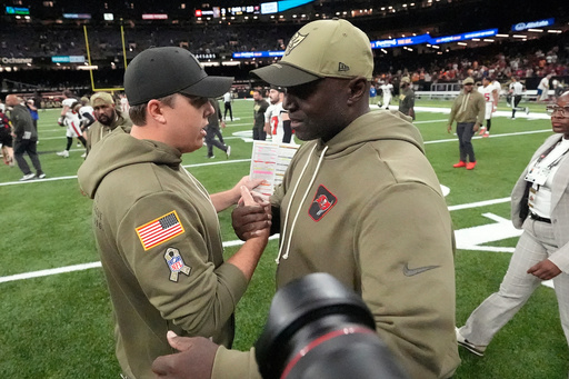 New Orleans Saints head coach Kellen Moore, left, shakes hands with Tampa Bay Buccaneers head coach Todd Bowles after an NFL football game Sunday, Oct. 26, 2025, in New Orleans. (AP Photo/Gerald Herbert) New Orleans Saints head coach Kellen Moore, left, shakes hands with Tampa Bay Buccaneers head coach Todd Bowles after an NFL football game Sunday, Oct. 26, 2025, in New Orleans. (AP Photo/Gerald Herbert)