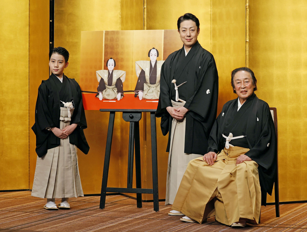 Kabuki actors, from right to left, the seventh Kikugoro Onoe, his son Kikunosuke Onoe and his grandson, Ushinosuke Onoe pose for a photo after a press conference in Tokyo, on May 27, 2024. (Kyodo News via AP)