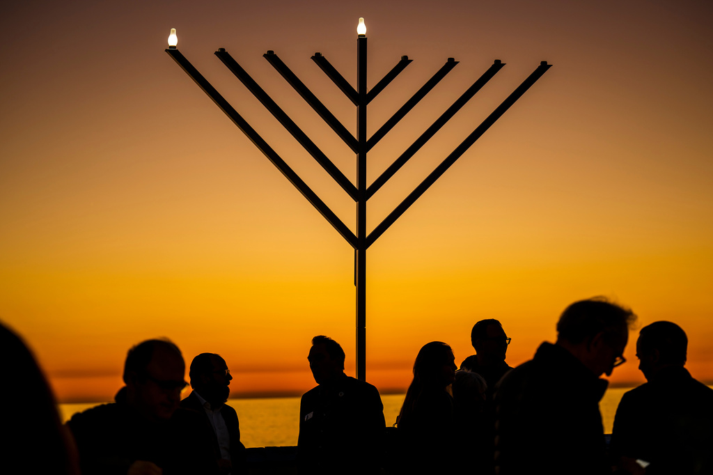 FILE - People gather around the 10-foot menorah during the "Hanukkah on the Pier" event at the end of the San Clemente pier hosted by Chabad of San Clemente in San Clemente, Calif., Sunday, Dec. 18, 2022. (Leonard Ortiz/The Orange County Register via AP, File)