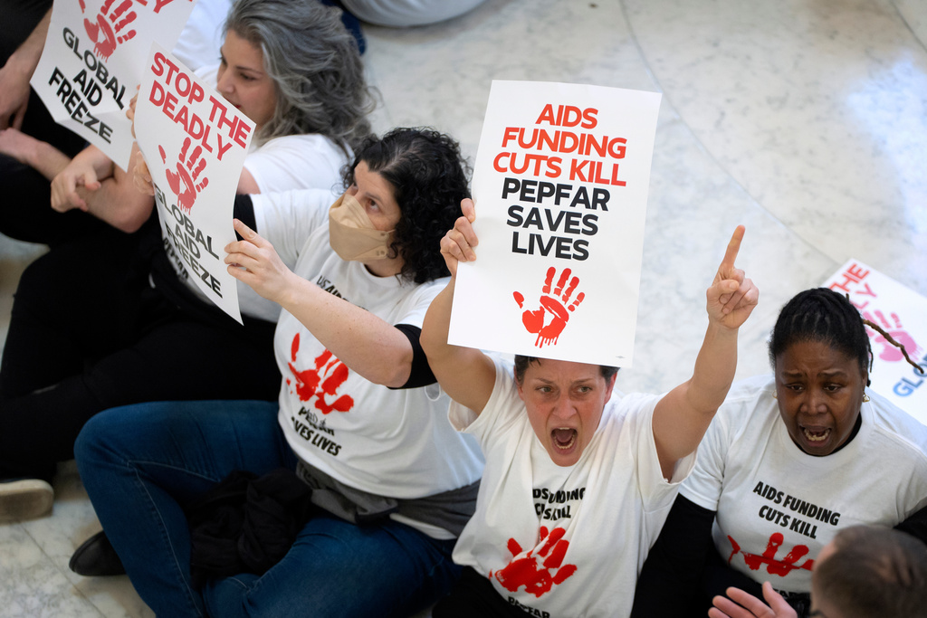 FILE - Demonstrators protest against cuts to American foreign aid spending, including USAID and the PEPFAR program to combat HIV/AIDS, at the Cannon House Office Building on Capitol Hill, Wednesday, Feb. 26, 2025, in Washington. (AP Photo/Mark Schiefelbein, File)