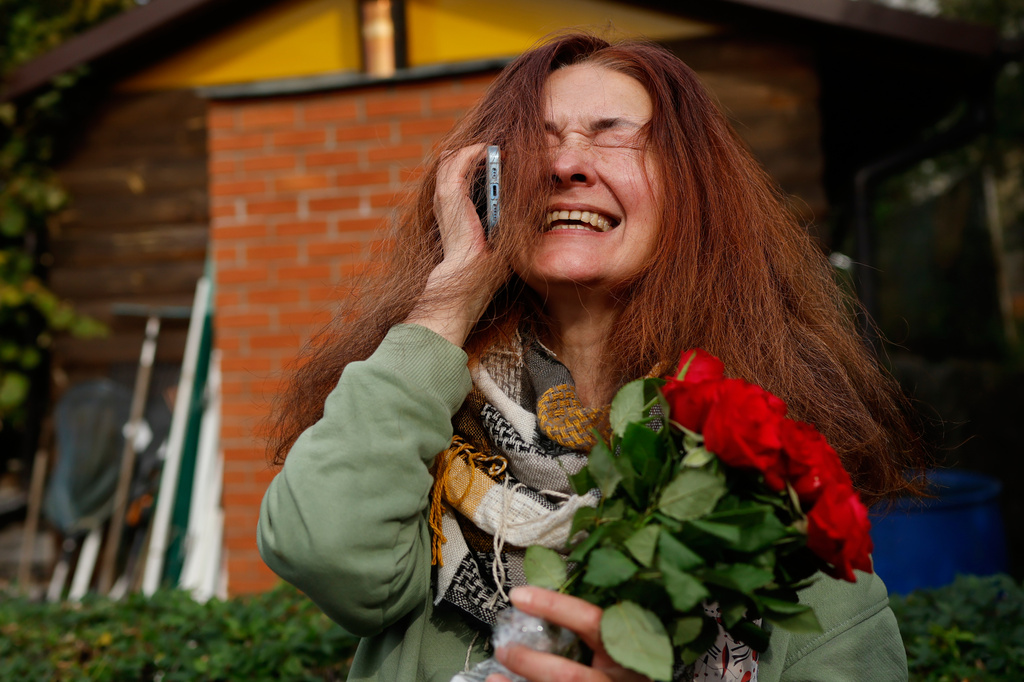 Tatsiana Kouzina, one of the released Belarusian prisoners reacts as she speaks on the phone upon her arrival in Vilnius, Lithuania, Wednesday, Sept. 16, 2026. (AP Photo/Mindaugas Kulbis)