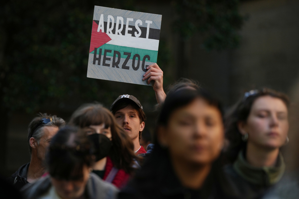 Demonstrators gather in Melbourne, Thursday, Feb. 12, 2026, to protest the visit to Australia by Israeli President Isaac Herzog. (AP Photo/Asanka Brendon Ratnayake)