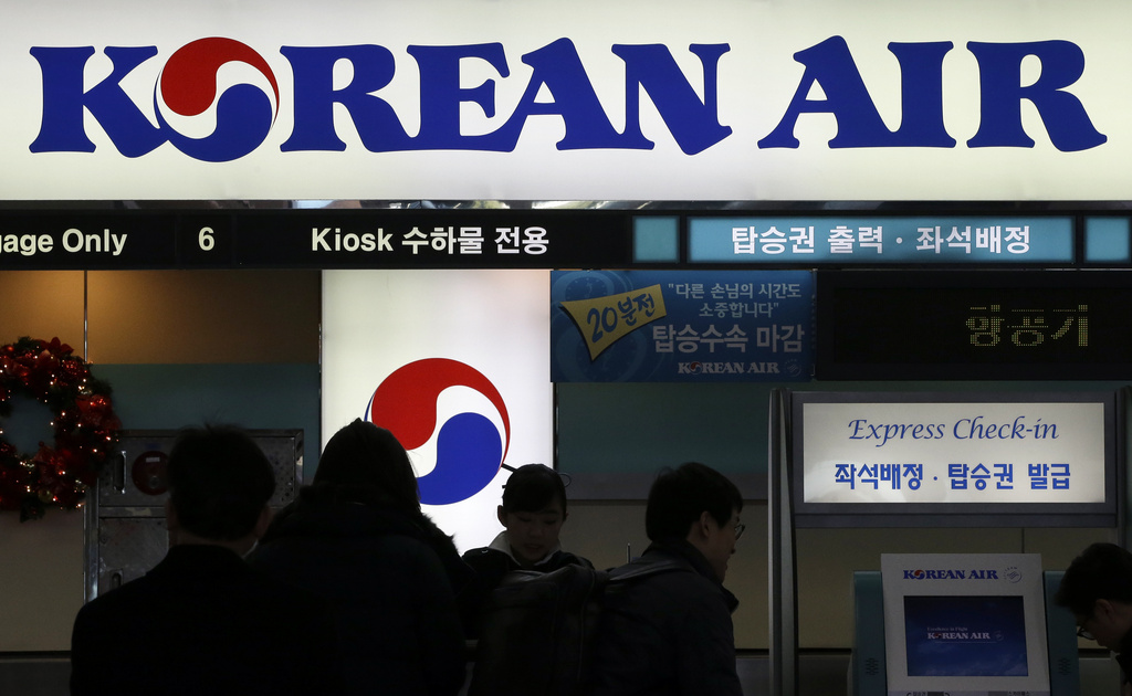 FILE - In this Dec. 16, 2014 photo, passengers wait to check in at the domestic check-in desk of Korean Air Lines Co. at Gimpo Airport in Seoul, South Korea. (AP Photo/Lee Jin-man, File)