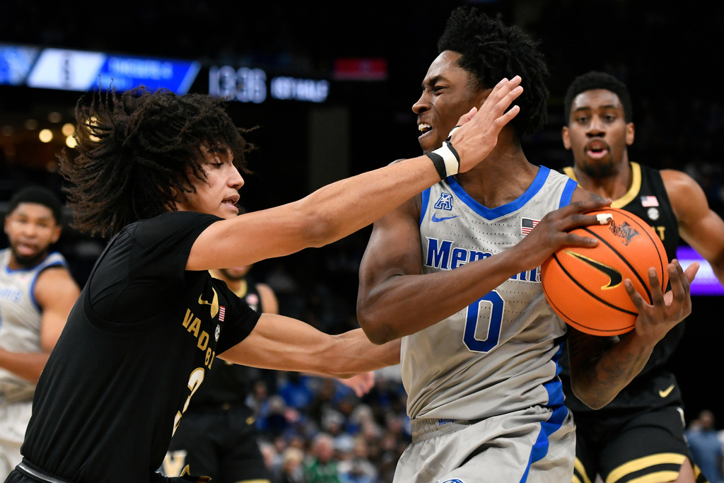 Memphis guard Quante Berry (0) handles the ball against Vanderbilt guard Tyler Tanner (3) in the first half of an NCAA college basketball game Wednesday, Dec. 17, 2025, in Memphis, Tenn. (AP Photo/Brandon Dill)
