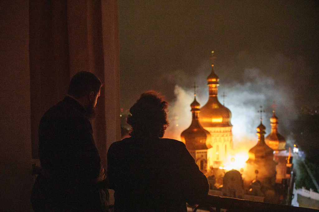 Bishop Avraamiy, right, of the Kyiv-Pechersk Lavra of the Orthodox Church of Ukraine, looks at the burning Dormition Cathedral of Kyiv-Pechersk Lavra, also known as the Monastery of the Caves, during a Russian strike on Kyiv, Ukraine, on Monday, June 15, 2026. (AP Photo/Evgeniy Maloletka)