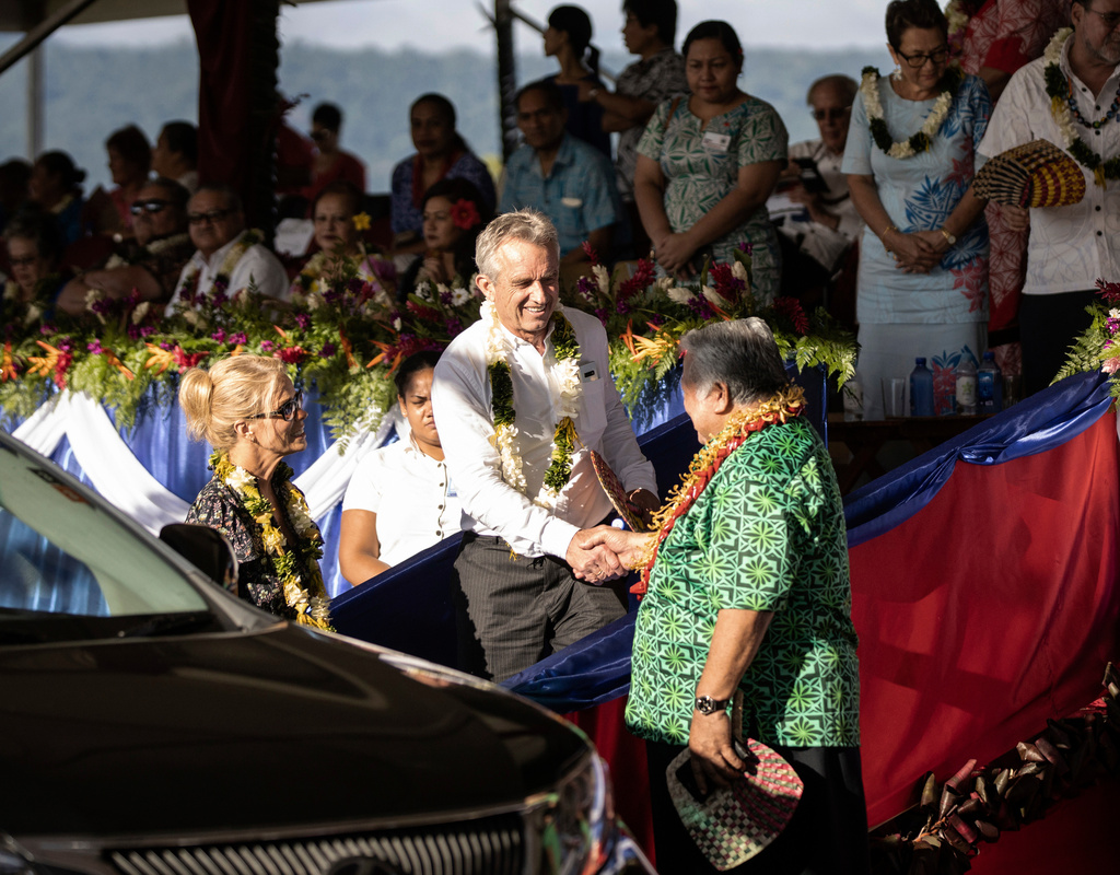 FILE - Prime Minister Tuilaepa Sailele Malielegaoi, foreground right, shakes hands with Robert F. Kennedy Jr. at the the 57th Independence Celebration in Mulinu'u, Samoa, June 1, 2019. At foreground left is Kennedy's wife, actress Cheryl Hines.(Misiona Simo/Samoa Observer via AP, File)