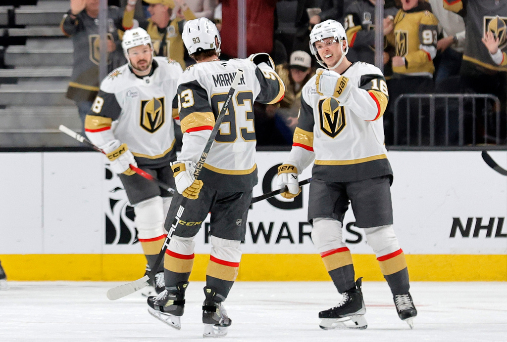 Vegas Golden Knights right wing Pavel Dorofeyev, right, celebrates with right wing Mitch Marner (93) after scoring against the Chicago Blackhawks during the first period of an NHL hockey game Saturday, March 14, 2026, in Las Vegas. Vegas Golden Knights center Tomas Hertl (48) looks on at left. (AP Photo/Steve Marcus)