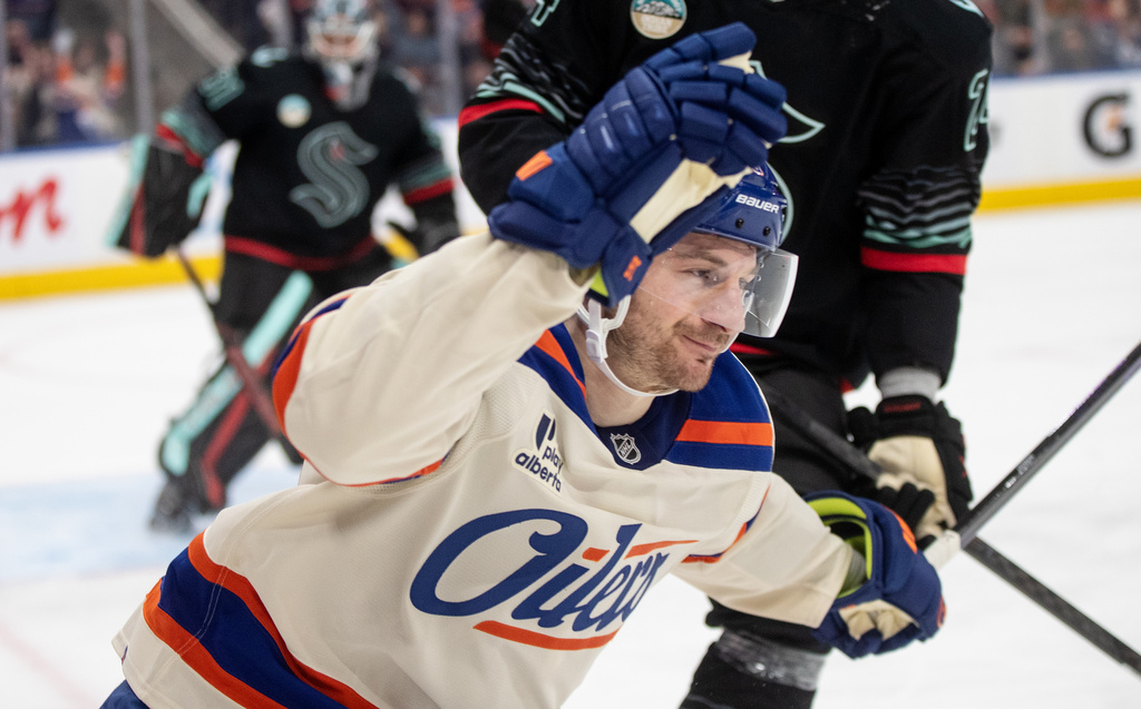 Edmonton Oilers' Zach Hyman (18) celebrates a goal against the Seattle Kraken during second period NHL action, in Edmonton on Thursday, Dec. 4, 2025. (Jason Franson/The Canadian Press via AP)