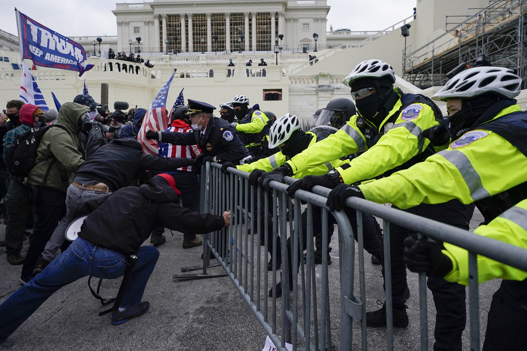 FILE - Metropolitan Police Department officers try to hold back rioters on the West Front at the U.S. Capitol on Jan. 6, 2021, in Washington. (AP Photo/Julio Cortez, File)