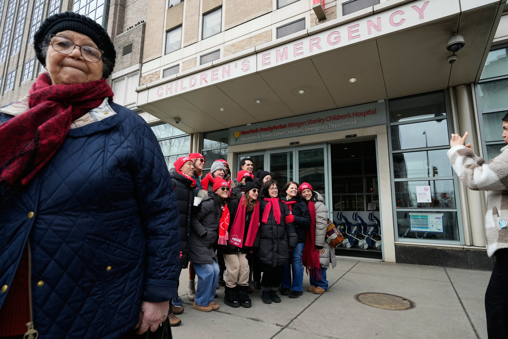 A group of striking nurses and their supporters take a picture in front of NewYork-Presbyterian hospital in New York, Thursday, Feb. 19, 2026. (AP Photo/Seth Wenig)