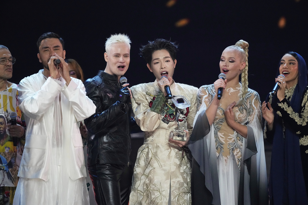 Vietnam's Duc Phuc, center, the winner of the International Music Competition "Intervision" and other participants sing at the Live Arena outside Moscow, Russia, Sunday, Sept. 21, 2025. (AP Photo/Alexander Zemlianichenko)