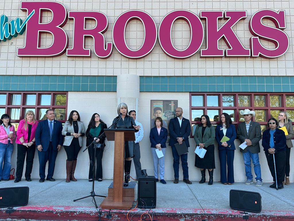 New Mexico Gov. Michelle Lujan Grisham, center, is flanked by state lawmakers as she announces the state will temporarily backfill SNAP benefits during a news conference outside a grocery store in Albuquerque, New Mexico, on Wednesday, Oct. 29, 2025. (AP Photo/Susan Montoya Bryan)