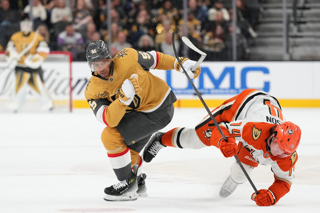 Vegas Golden Knights right wing Keegan Kolesar (55) collides with Anaheim Ducks defenseman Drew Helleson (14) in the second period of an NHL hockey game Saturday, Nov. 8, 2025, in Las Vegas. (AP Photo/Candice Ward)