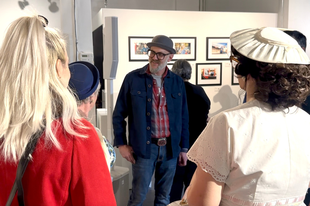 Photographer David J. Schwartz talks about photos he has made while traveling Route 66 over two decades, during an exhibition opening in Springfield, Ill., on March 27, 2026. (AP Photo/John O'Connor)