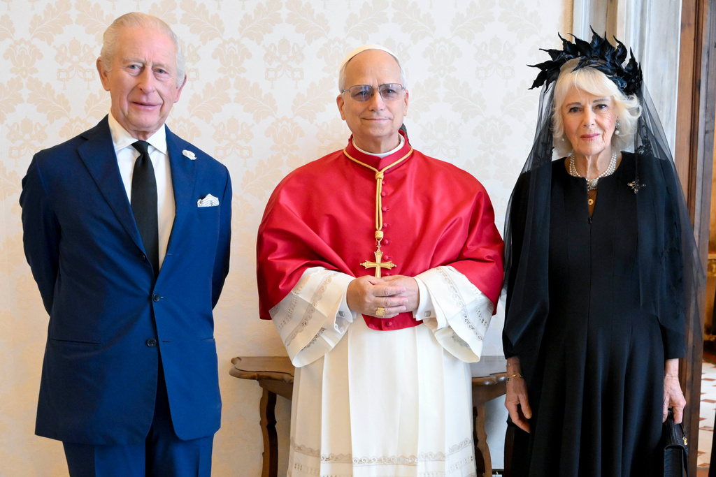In this picture made available by Vatican Media, Britain's King Charles III and Queen Camilla pose with Pope Leo XIV as they meet at the Vatican during a state visit, Thursday, Oct. 23, 2025. (Vatican Media via AP, HO)
